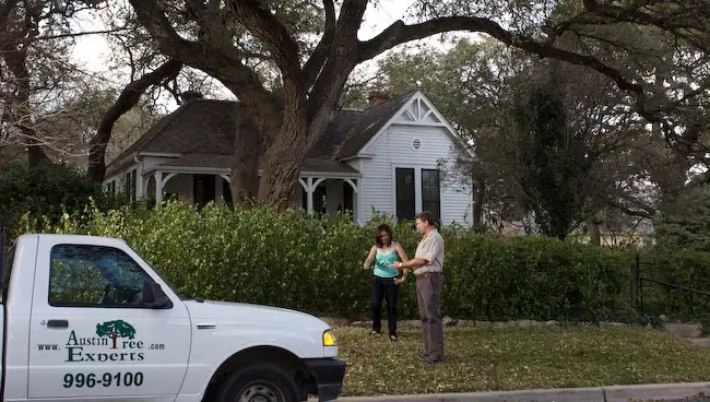 Austin Tree Experts arborist consulting with a customer at a residential property